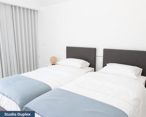 Katil atau katil-katil dalam bilik di TRIADE Apartamentos
