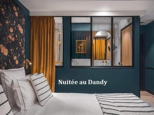 a bedroom with a bed with a blue wall at Love Hôtel avec nuit insolite au Dandy et Jacuzzi privatisé in Paris