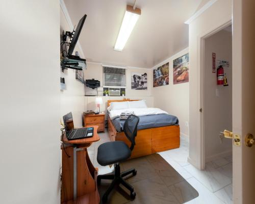 a bedroom with a bed and a desk and a chair at Booking.Com Exxlusive: Fully Furnished One Bedroom Entire Apartment With Full Size Bed. For One Person Or Couple, Soulmate Positive Friendship in Brooklyn