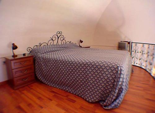 a bedroom with a bed and a wooden floor at Ludovica Tipo D in Positano