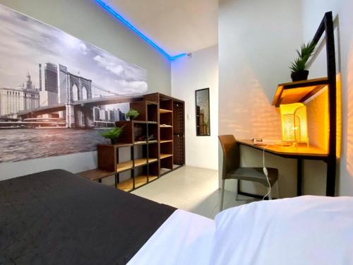 a bedroom with a desk and a bed and a deskablish at ROOMIES HOSTEL Parque México in Mexico City
