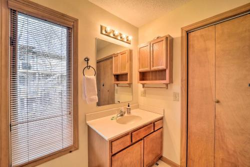 a bathroom with a sink and a mirror at Decks and Scenic Views Beech Mountain Cabin! in Beech Mountain