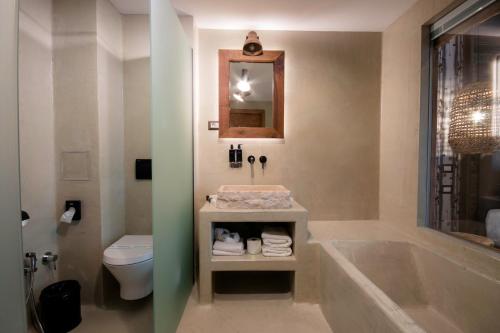 a bathroom with a tub and a toilet and a sink at HANUL BUCOVINEI in Câmpulung Moldovenesc