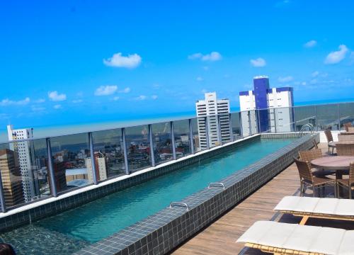 a swimming pool on the roof of a building at Flat Alto Padrão em Tambaú in João Pessoa