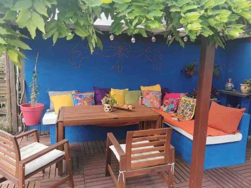 a patio with a table and chairs and a couch at Spacious Villa in Dilbeek with Private Garden, Ideal for Families & Business in Dilbeek