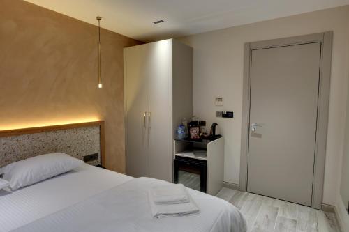 a bedroom with a white bed and a bathroom at 21 Rooms Hotel in Istanbul