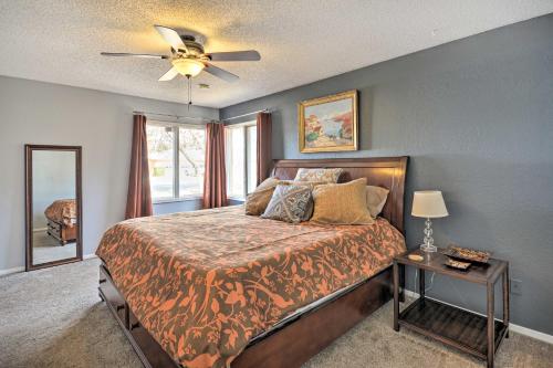 a bedroom with a bed and a ceiling fan at Lubbock Townhome with Grill Near TTU and Downtown! in Lubbock