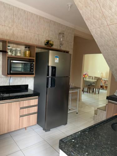 a kitchen with a stainless steel refrigerator at Residência lençóis in Barreirinhas