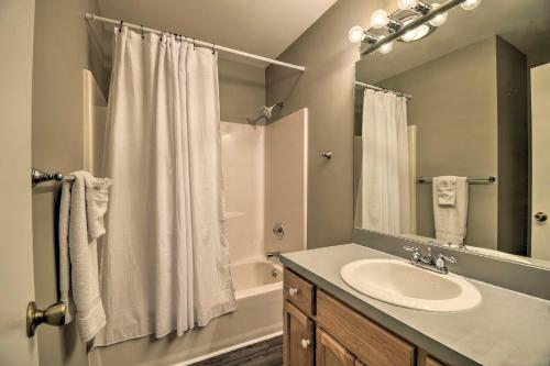 een badkamer met een wastafel en een douche met een spiegel bij Canal Front Sunset Beach Home Steps to Ocean! in Sunset Beach