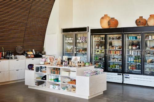 a store with lots of glass doors and shelves at AutoCamp Joshua Tree in Joshua Tree