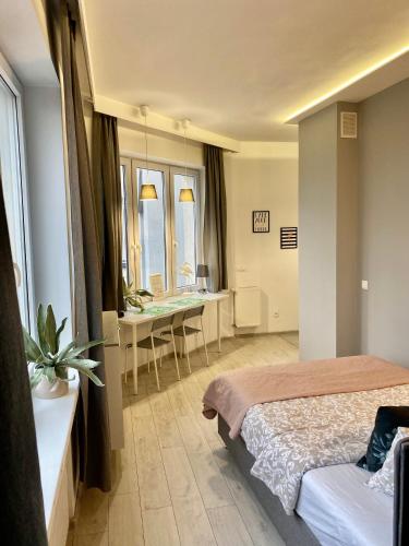a bedroom with a bed and a desk in a room at Exclusive Apartments Smolna in Warsaw