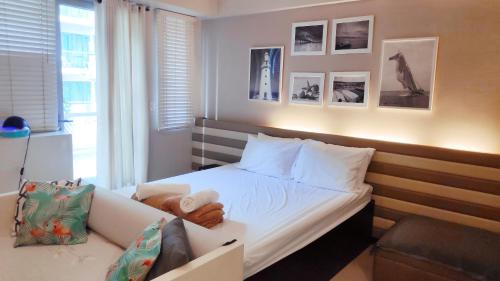 a small bedroom with a bed and a window at Palm Tree Condos across NAIA3 by Beth in Manila