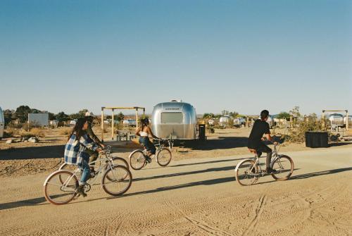 a group of people riding bikes on a dirt road at AutoCamp Joshua Tree in Joshua Tree