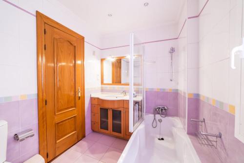 a bathroom with a tub and a sink at La Casita de Gracia in Monachil