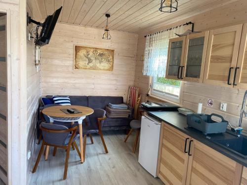 a small kitchen with a table in a tiny house at Dolina Wisełka in Wisełka