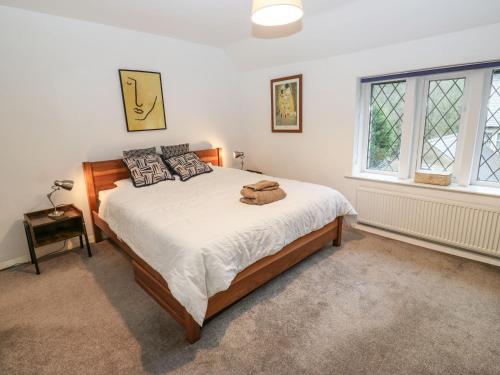 a bedroom with a bed and a window at Woods Lane Cottage in Oldham