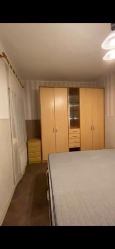 a bedroom with a bed and wooden cabinets at Calle la cadena 23 varea, Logroño in Logroño