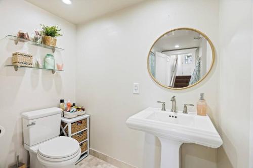 a white bathroom with a sink and a mirror at Beautiful 5 bedroom home just steps from the beach in Santa Cruz
