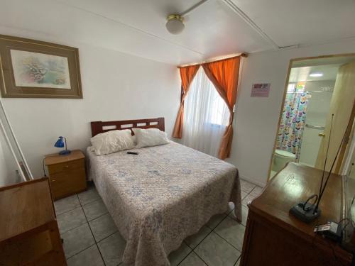 a bedroom with a bed and a window at Rincon de Las Condes in Santiago