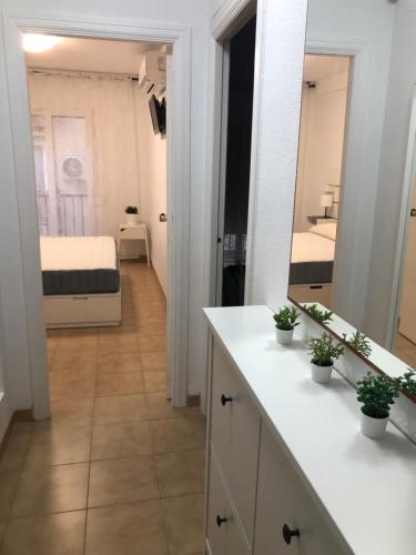 a bathroom with a white counter and a bedroom at Sant Vicent 35 in heart of Old town in Benidorm