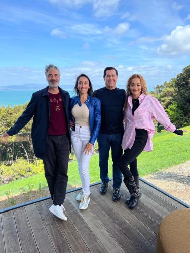 a group of people posing for a picture on a deck at Omana in Rocky Bay