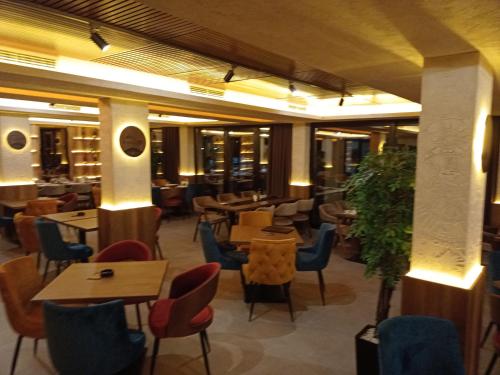 a restaurant with tables and chairs in a building at Milmari N Lux 52 in Kopaonik