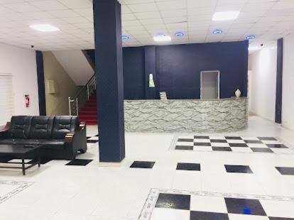 a lobby with chairs and a counter in a building at Andalusia Hotel in Nouakchott