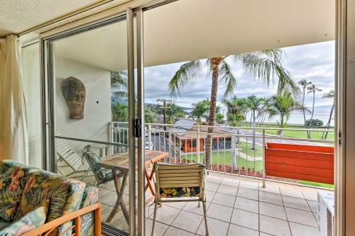 a room with a balcony with a table and chairs at Condo with Private Lanai, Ocean View and On-Site Pool! in Kihei