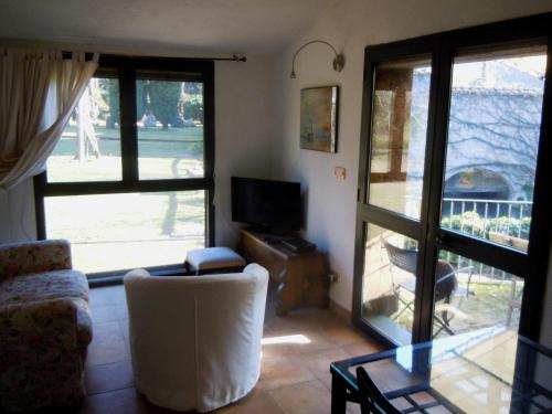 a living room with a couch and a table and a tv at La Cannara in Marta