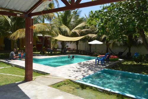 a swimming pool with people in a resort at RANCHO BOLMAR. Playa Metalio. Sonsonate. in Acajutla