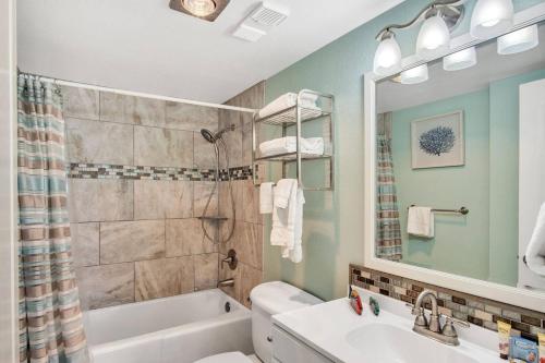 a bathroom with a tub and a sink at Beautiful Ocean Views and Spacious Elegant Comfort Indoors in This 3 Bedroom 3 Bath with Den in Port Aransas
