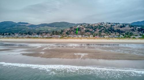 Vistas a una playa con una ciudad en el fondo en The Sand Castle - Meredith Lodging, en Rockaway Beach