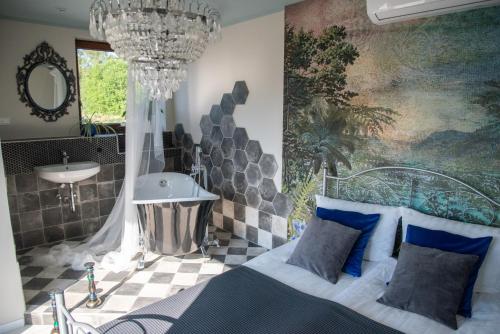 a bedroom with a bed and a sink and a chandelier at Komfort Zone in Wolfsburg