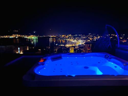a blue bath tub with a city at night at Penthouse Maus in Trogir