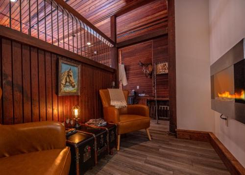 a living room with a couch and a chair at Cartier Mansion in Ludington