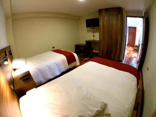 Ένα ή περισσότερα κρεβάτια σε δωμάτιο στο Zans Apartments Cusco