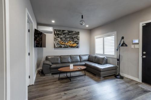 a living room with a couch and a table at Fam Friendly 2BD 8min from airport, 4min from SoFi in Los Angeles