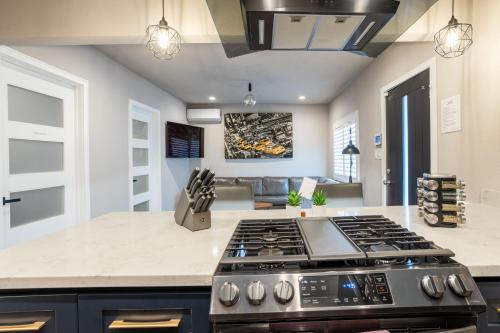 a kitchen with a stove top oven in a room at Fam Friendly 2BD 8min from airport, 4min from SoFi in Los Angeles