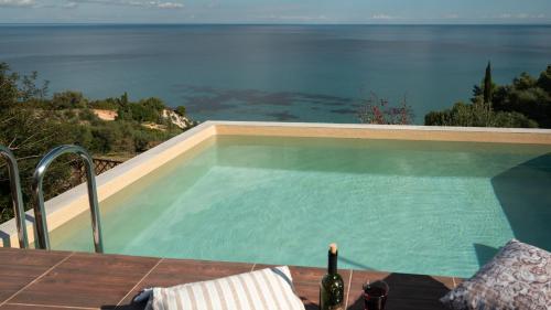 a swimming pool with a view of the ocean at Xigia Escape villas in Khartáta