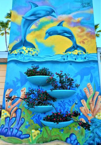 a mural of dolphins in the ocean at Johns Pass Beach Motel in St Pete Beach