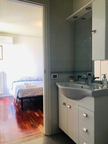 a bathroom with a sink and a mirror at B&B La Chicca in Ravenna