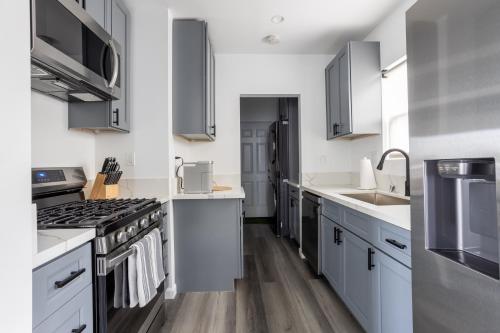 a kitchen with white counters and stainless steel appliances at Bungalow w Free Parking 4 min from SoFi, 8min from airport in Los Angeles