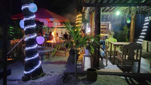 a room with a table and chairs with lights at Treasure Beach Resort in Carles