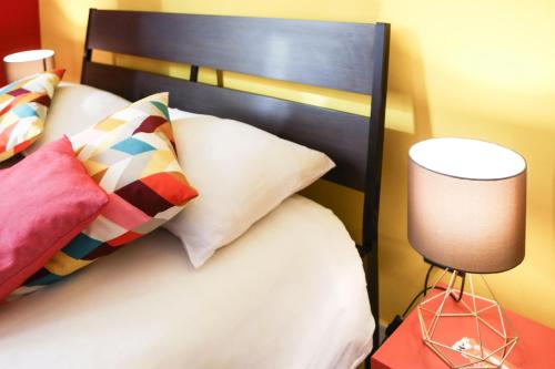 a bedroom with a bed with a black headboard and a lamp at Materdays 24 in Naples