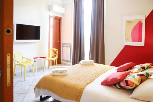 a bedroom with a large bed and a tv at Materdays 24 in Naples