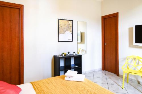 a bedroom with a bed and a yellow chair at Materdays 24 in Naples