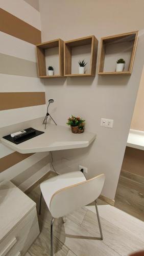 a white desk and a chair in a room at Sicily in Love - Rooms & Breakfast in Taormina