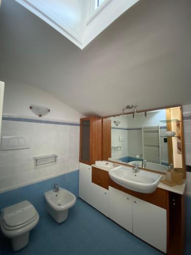 a bathroom with a sink and a toilet and a mirror at Palazzotto Morelli in Matera