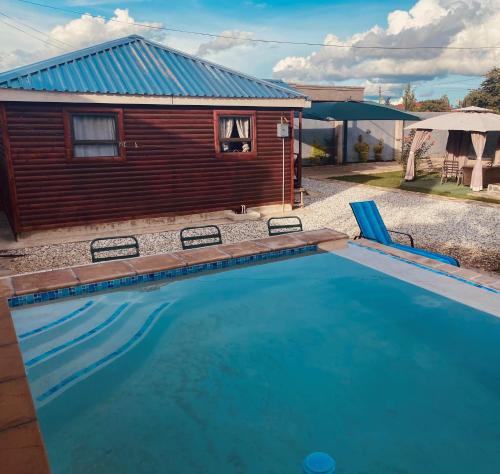 a large swimming pool in front of a house at Samkab Legacy & Comfort in Lusaka