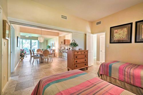 a bedroom with two beds and a dining room at Waikoloa Village Condo with Pool and Golf Course Views in Waikoloa